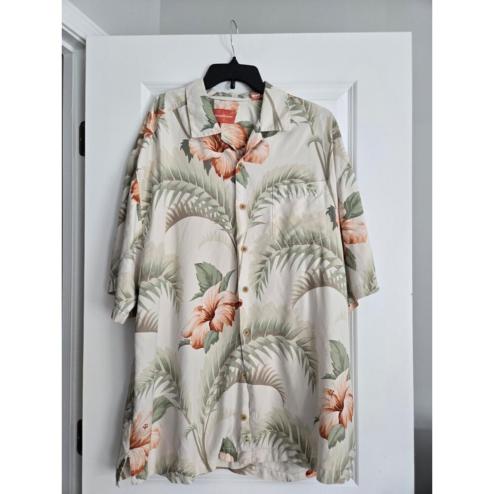 Tommy Bahama creme silk Hawaiian shirt featuring a tropical print of orange hibi